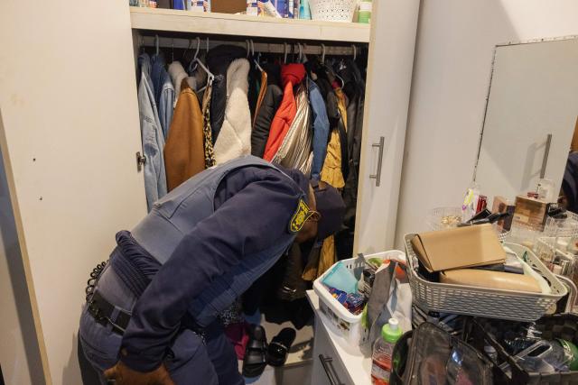 South African policemen search a house during the crime prevention operation Shanela in Tafelsig, Cape Town on February 13, 2026. Operation Shanela, "to sweep" in Setswana, is a high-density, multi-disciplinary, and countrywide crime-fighting initiative led by the South African Police Service (SAPS) to combat serious crime, specifically targeting hotspots, illegal mining, and unlicensed firearms. (Photo by GIANLUIGI GUERCIA / AFP)