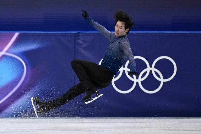 China's Jin Boyang falls while competing in the figure skating men's singles free skating final during the Milano Cortina 2026 Winter Olympic Games at Milano Ice Skating Arena in Milan on February 13, 2026. (Photo by WANG Zhao / AFP)