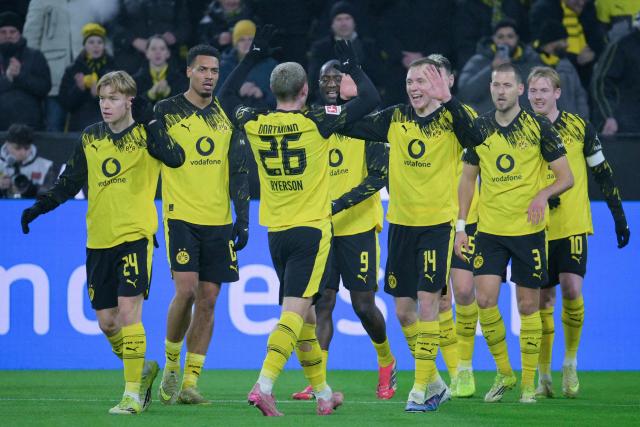 Dortmund's German forward #14 Maximilian Beier celebrates scoring the 2-0 goal with his teammates during the German first division Bundesliga football match between Borussia Dortmund and Mainz 05 in Dortmund, western Germany, on February 13, 2026. (Photo by Sascha Schuermann / AFP) / DFL REGULATIONS PROHIBIT ANY USE OF PHOTOGRAPHS AS IMAGE SEQUENCES AND/OR QUASI-VIDEO