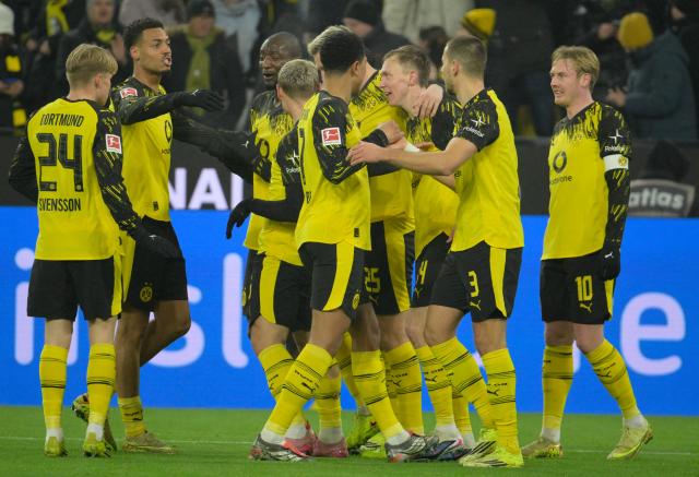 Dortmund's German forward #14 Maximilian Beier celebrates scoring the 2-0 goal with his teammates during the German first division Bundesliga football match between Borussia Dortmund and Mainz 05 in Dortmund, western Germany, on February 13, 2026. (Photo by Sascha Schuermann / AFP) / DFL REGULATIONS PROHIBIT ANY USE OF PHOTOGRAPHS AS IMAGE SEQUENCES AND/OR QUASI-VIDEO