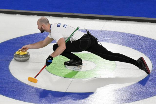 Italy's Amos Mosaner delivers the stone in the curling men's round robin between Germany and Italy during the Milano Cortina 2026 Winter Olympic Games at the Cortina Curling Olympic Stadium in Cortina d’Ampezzo on February 13, 2026. (Photo by Tiziana FABI / AFP)