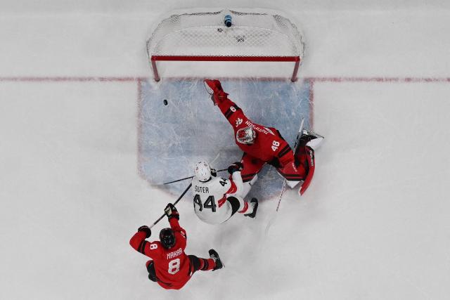 Switzerland's #44 Pius Suter (C) scores a goal  during the men's preliminary round Group A Ice Hockey match between Canada and Switzerland at the Milano Santagiulia Ice Hockey Arena during the Milano Cortina 2026 Winter Olympic Games in Milan, on February 13, 2026. (Photo by Alexander NEMENOV / AFP)