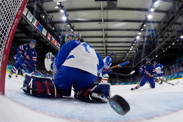 USA's defender #05 Megan Keller shoots past Italy's #01 Gabriella Frances Durante ans scores her team first goal during the women's quarter final Ice Hockey match between USA and Italy at the Milano Rho Ice Hockey Arena at the Milano Cortina 2026 Winter Olympic Games in Milan, on February 13, 2026. (Photo by Darko Bandic / POOL / AFP)
