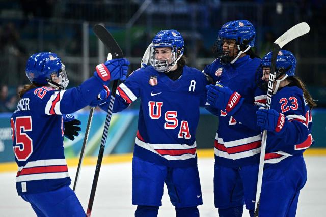 USA's defender #05 Megan Keller (2nd R) celebrates with teammates after scoring her team first goal during the women's quarter final Ice Hockey match between USA and Italy at the Milano Rho Ice Hockey Arena at the Milano Cortina 2026 Winter Olympic Games in Milan, on February 13, 2026. (Photo by JULIEN DE ROSA / AFP)