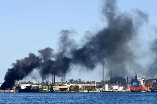 Black smoke billows from a fire at the Nico Lopes oil refinery in Havana on February 13, 2026. (Photo by YAMIL LAGE / AFP)