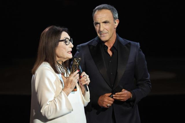 Greek singer Nana Mouskouri reacts after receiving a special award from French TV host Nikos Aliagas during the Victoires de la Musique music awards ceremony at La Seine Musicale in Boulogne-Billancourt on February 13, 2026. (Photo by Alain JOCARD / AFP)