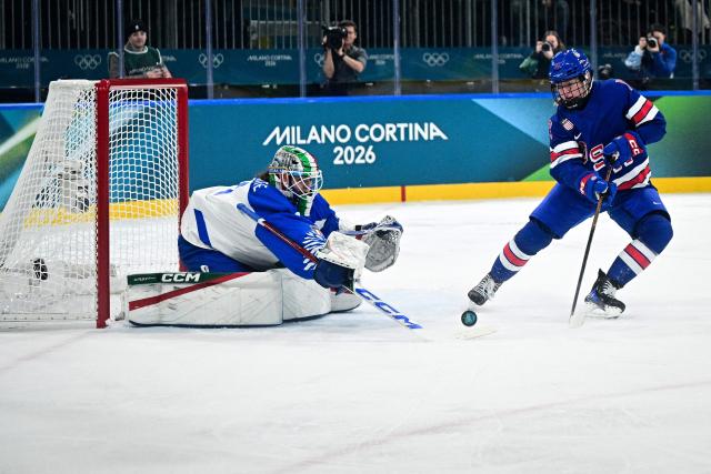 USA's forward #13 Grace Zumwinkle fights for the puck with Italy's #01 Gabriella Frances Durante during the women's quarter final Ice Hockey match between USA and Italy at the Milano Rho Ice Hockey Arena at the Milano Cortina 2026 Winter Olympic Games in Milan, on February 13, 2026. (Photo by JULIEN DE ROSA / AFP)