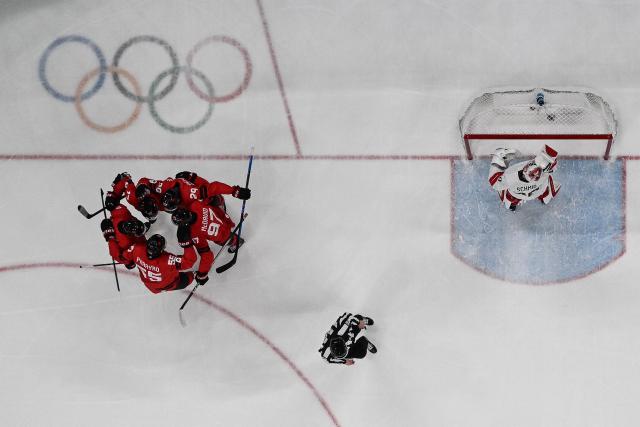 Canada's players celebrate a team goal  during the men's preliminary round Group A Ice Hockey match between Canada and Switzerland at the Milano Santagiulia Ice Hockey Arena during the Milano Cortina 2026 Winter Olympic Games in Milan, on February 13, 2026. (Photo by Alexander NEMENOV / AFP)