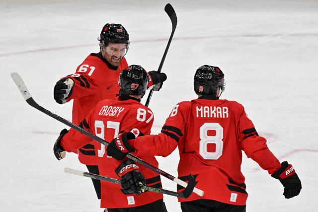Canada's #87 Sidney Crosby (C) celebrates with teammates after scoring a goal  during the men's preliminary round Group A Ice Hockey match between Canada and Switzerland at the Milano Santagiulia Ice Hockey Arena during the Milano Cortina 2026 Winter Olympic Games in Milan, on February 13, 2026. (Photo by Alexander NEMENOV / AFP)