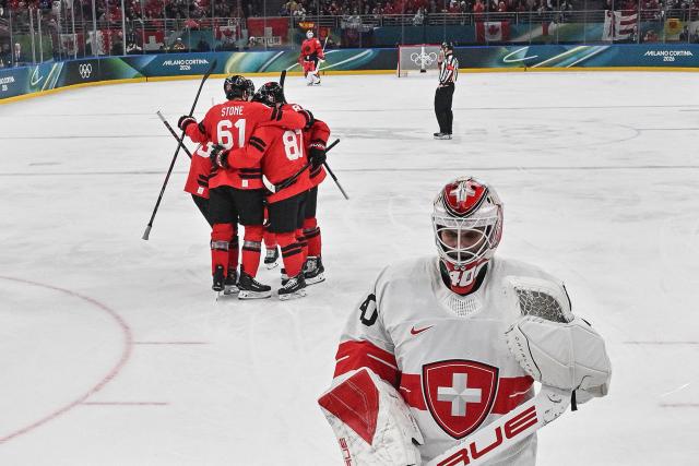 Canada's players celebrate a team goal  during the men's preliminary round Group A Ice Hockey match between Canada and Switzerland at the Milano Santagiulia Ice Hockey Arena during the Milano Cortina 2026 Winter Olympic Games in Milan, on February 13, 2026. (Photo by Alexander NEMENOV / POOL / AFP)