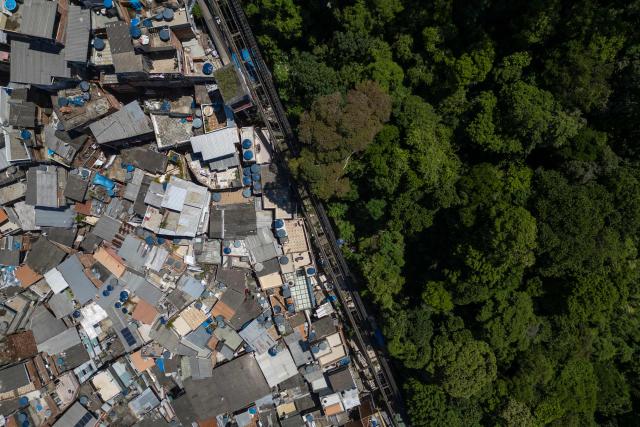 Aerial view show the Santa Marta favela in the south zone of Rio de Janeiro, Brazil, on February 13, 2026. The Santa Marta favela, located on Dona Marta Hill between Botafogo and Laranjeiras in Rio de Janeiro's South Zone, is a vibrant community of roughly 3,900–6,000 residents. It is a popular, generally safe tourist destination famous for its steep terrain, colorful houses, and the Michael Jackson statue marking where his 1995 music video was filmed. (Photo by MAURO PIMENTEL / AFP)