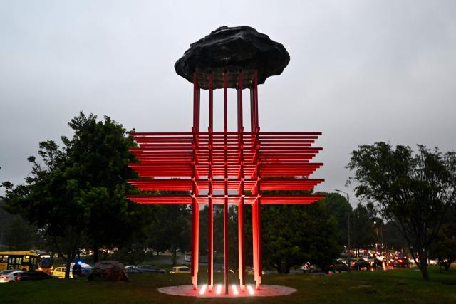 The New “Umbral” monument, which pays tribute to medical personnel who died during the Covid-19 pandemic, is pictured in Bogota on February 13, 2026. Created by Colombian artist Carlos Castro, it honors those who lost their lives during the pandemic. Standing over 11 meters high and 7 meters wide, it is represented by the universal symbol of the cross, an emblem conceived to protect life in hostile scenarios and, since its origins, to evoke the presence of medical personnel providing aid, neutrality, and humanity. (Photo by Raul ARBOLEDA / AFP)