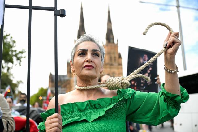 A member of the Iranian community holds a gallows rope as she marches during a rally in Sydney on February 14, 2026, calling for stronger international action and urging the United States to intervene against the current Iranian regime. (Photo by Saeed KHAN / AFP)