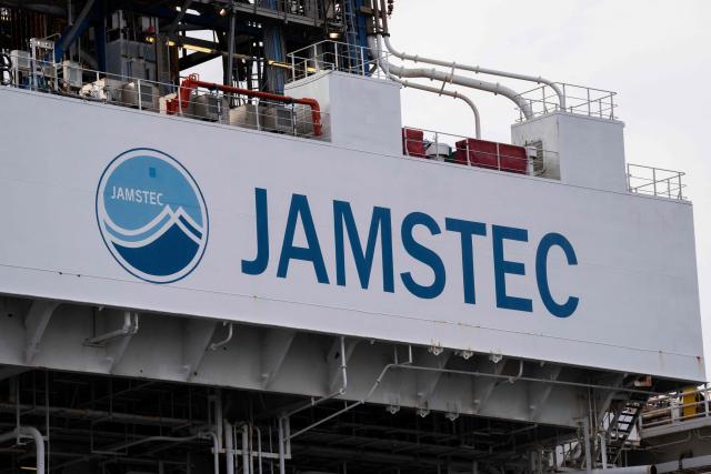 The logo of Japan Agency for Marine-Earth Science and Technology (JAMSTEC) is seen on Japan's deep-sea drilling vessel Chikyu at Shimizu port in Shimizu, Shizuoka prefecture on February 14, 2026. (Photo by Yuichi YAMAZAKI / AFP)