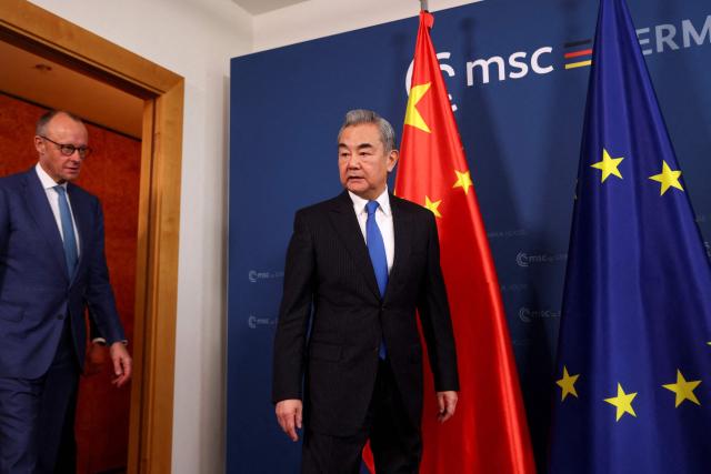 German Chancellor Friedrich Merz (L) and Chinese Foreign Minister Wang Yi meet for bilateral talks during the 62nd Munich Security Conference (MSC) on February 14, 2026 in Munich, southern Germany. (Photo by Thilo Schmuelgen / POOL / AFP)