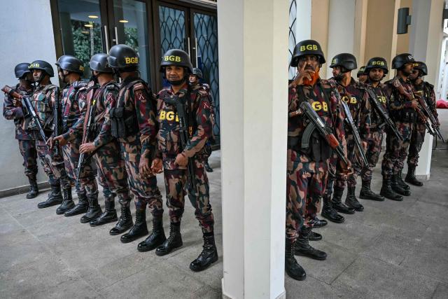 Border Guard Bangladesh (BGB) personnel stand guard outside the conference room where Bangladesh Nationalist Party (BNP) chairman Tarique Rahman is addressing media in Dhaka on February 14, 2026. Election Commission figures showed Rahman's BNP had won a landslide victory in the elections on February 12, the first since a deadly 2024 uprising ousted the iron-fisted rule of Sheikh Hasina. (Photo by MOHD RASFAN / AFP)