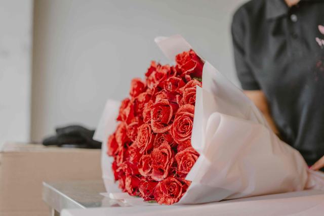 Lauryne from Wild Flower Gifting prepares a rose bouquet for delivery on the eve of Valentine’s Day in Nairobi, on February 13, 2026. (Photo by Fredrik Lerneryd / AFP)