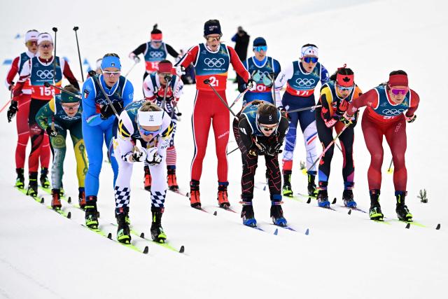 (From L) Sweden's Linn Svahn, Germany's Laura Gimmler, Switzerland's Anja Weber and fellow athletes compete during the cross-country women's 4 x 7,5km relay event of the Milano Cortina 2026 Winter Olympic Games at Tesero Cross-Country Skiing Stadium in Lago di Tesero (Val di Fiemme), on February 14, 2026. (Photo by Tobias SCHWARZ / AFP)