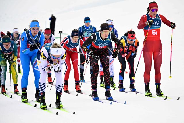 (From L) Sweden's Linn Svahn, Germany's Laura Gimmler, Switzerland's Anja Weber and fellow athletes compete during the cross-country women's 4 x 7,5km relay event of the Milano Cortina 2026 Winter Olympic Games at Tesero Cross-Country Skiing Stadium in Lago di Tesero (Val di Fiemme), on February 14, 2026. (Photo by Tobias SCHWARZ / AFP)