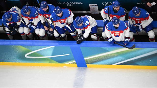 Slovakia's players on the bench follow the men's preliminary round Group B Ice Hockey match between Sweden and Slovakia at the Milano Santagiulia Ice Hockey Arena during the Milano Cortina 2026 Winter Olympic Games in Milan, on February 14, 2026. (Photo by JULIEN DE ROSA / AFP)