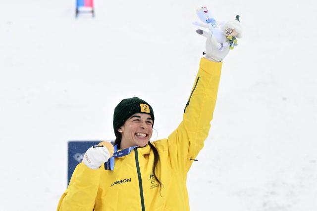 Gold medallist Australia's Jakara Anthony celebrates on the podium after the freestyle skiing women's dual moguls final during the Milano Cortina 2026 Winter Olympic Games at Livigno Aerials & Moguls Park, in Livigno (Valtellina), on February 14, 2026. (Photo by Jeff PACHOUD / AFP)