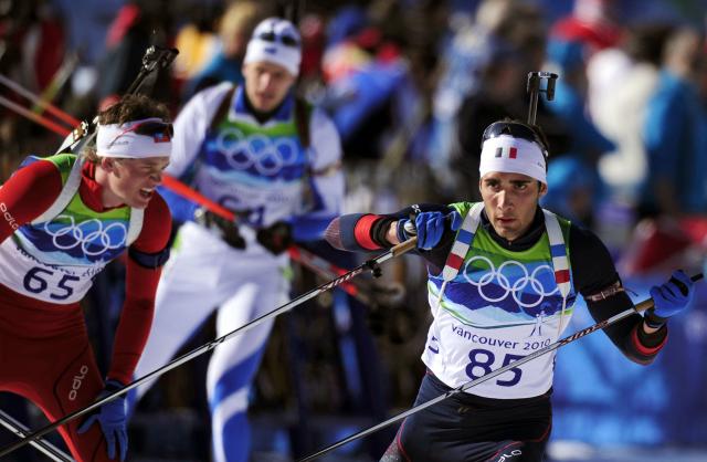 (FILES) Norway's Tarjei Boe  (L) and France's Martin Fourcade (R) compete during the men's Biathlon 20 km individual at the Whistler Olympic Park during the Vancouver Winter Olympics on February 18, 2010. (Photo by Franck FIFE / AFP)