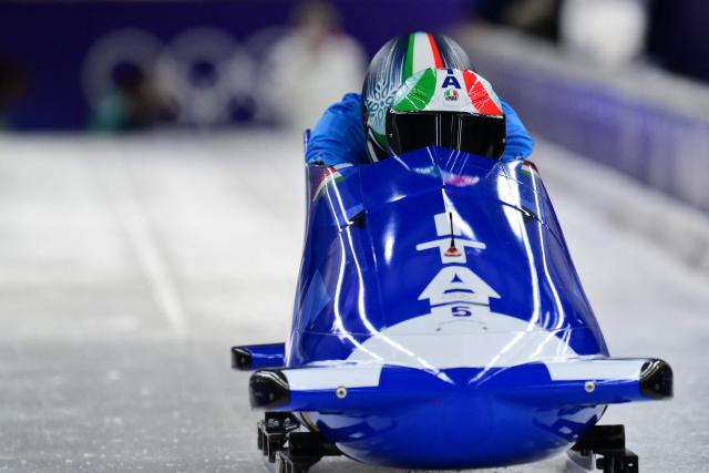 Italy's Patrick Baumgartner pilots in the bobsleigh men's 2-man training session at Cortina Sliding Centre during the Milano Cortina 2026 Winter Olympic Games in Cortina d'Ampezzo on February 14, 2026. (Photo by Stefano RELLANDINI / AFP)