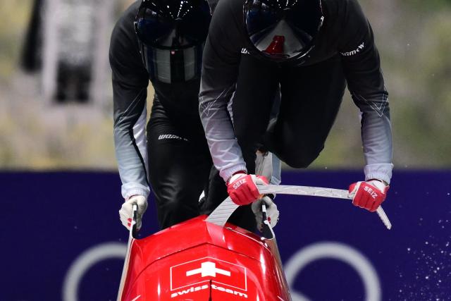 Switzerland's Timo Rohner takes starts in the bobsleigh men's 2-man training session at Cortina Sliding Centre during the Milano Cortina 2026 Winter Olympic Games in Cortina d'Ampezzo on February 14, 2026. (Photo by Stefano RELLANDINI / AFP)