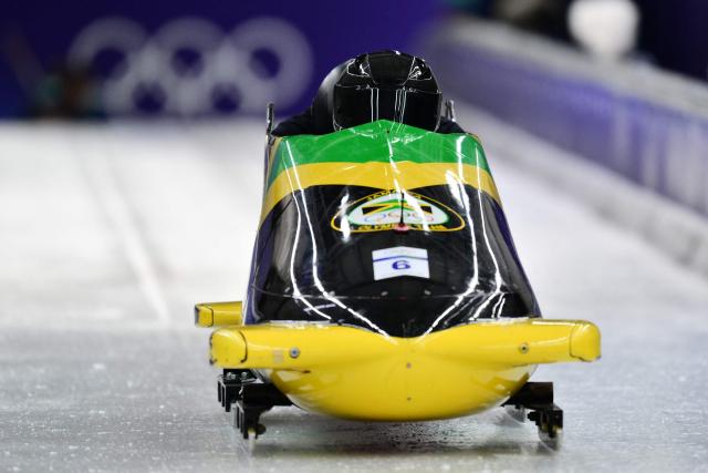 Jamaica's Shane Pitter pilots in the bobsleigh men's 2-man training session at Cortina Sliding Centre during the Milano Cortina 2026 Winter Olympic Games in Cortina d'Ampezzo on February 14, 2026. (Photo by Stefano RELLANDINI / AFP)