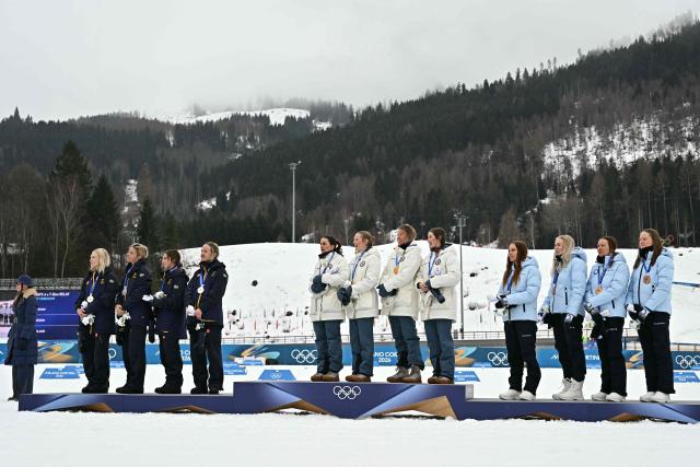 (From L) Silver medallists Sweden's Jonna Sundling, Sweden's Frida Karlsson, Sweden's Ebba Andersson and Sweden's Linn Svahn, gold medallists Norway's Heidi Weng, Norway's Karoline Simpson-Larsen, Norway's Astrid Oeyre Slind and Norway's Kristin Austgulen Fosnaes, and Bronze medallists Finland's Jasmi Joensuu, Finland's Vilma Ryytty, Finland's Kerttu Niskanen and Finland's Johanna Matintalo celebrate on the podium for the cross-country women's 4 x 7,5km relay event of the Milano Cortina 2026 Winter Olympic Games at Tesero Cross-Country Skiing Stadium in Lago di Tesero (Val di Fiemme), on February 14, 2026. (Photo by Javier SORIANO / AFP)