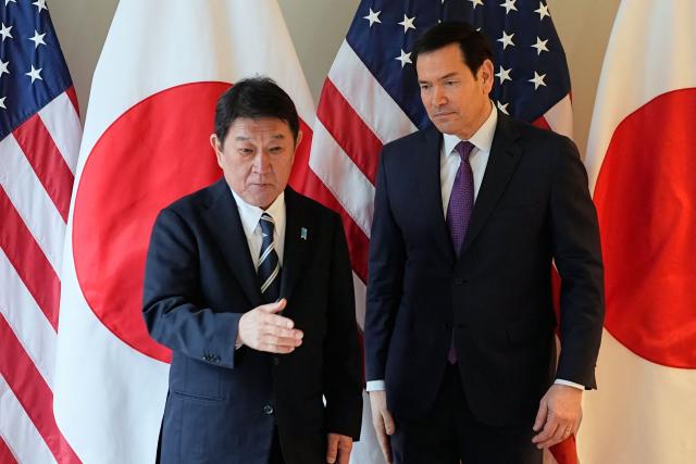 US Secretary of State Marco Rubio (R) and Japan's Foreign Minister Toshimitsu Motegi shake hands as they met on the sidelines of the  during the 62nd Munich Security Conference (MSC) on February 14, 2026 in Munich, southern Germany. Heads of state and government as well as foreign and defence ministers from all over the world are expected to attend the security policy talks from February 13 to 15, 2026. (Photo by Alex Brandon / POOL / AFP)