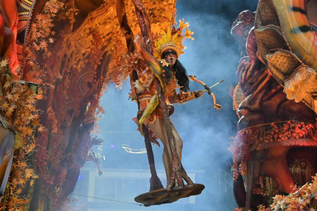 A reveller of the Dragoes da Real samba school performs during the carnival parade at the Anhembi Sambadrome in Sao Paulo, Brazil, on February 14, 2026. (Photo by NELSON ALMEIDA / AFP)