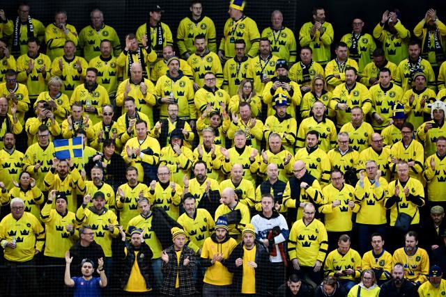 Sweden fans celebrate their team during the men's preliminary round Group B Ice Hockey match between Sweden and Slovakia at the Milano Santagiulia Ice Hockey Arena during the Milano Cortina 2026 Winter Olympic Games in Milan, on February 14, 2026. (Photo by JULIEN DE ROSA / AFP)