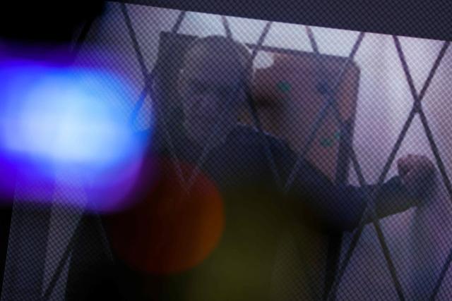 (FILES) Jailed Russian opposition figure Alexei Navalny is seen on a screen via a video link from the IK-3 penal colony above the Arctic circle during a hearing of his complaint on restrictions placed on which books and reading material he can access in prison, at the Supreme Court in Moscow on January 11, 2024. The "murder" of late Russian opposition politician Alexei Navalny in an Arctic prison in 2024 is now a "science-proven fact", his widow Yulia Navalnaya said on Feruary 14, 2026 after five European countries said Moscow used a lethal toxic on the Kremlin opponent. "Two years ago I came on stage here and said that it was Vladimir Putin who killed my husband," Navalnaya said on the sidelines of the Munich Security Conference. (Photo by Vera Savina / AFP)