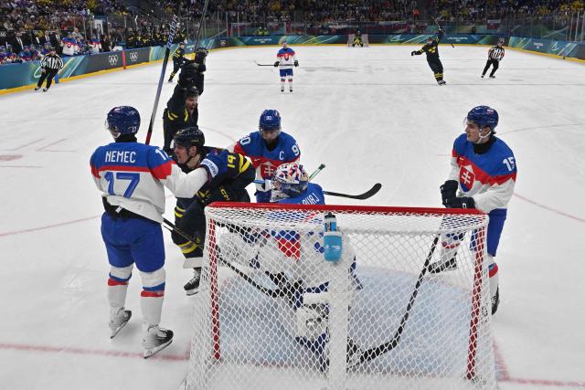 Sweden's #14 Joel Eriksson Ek (2L) celebrates scoring his team's first goal wiht Sweden's #19 Adrian Kempe during the men's preliminary round Group B Ice Hockey match between Sweden and Slovakia at the Milano Santagiulia Ice Hockey Arena during the Milano Cortina 2026 Winter Olympic Games in Milan, on February 14, 2026. (Photo by JULIEN DE ROSA / POOL / AFP)
