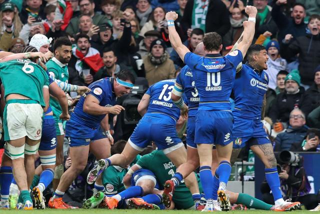Italy's players celebrate their first try during the Six Nations international rugby union match between Ireland and Italy at the Aviva Stadium in Dublin, on February 14, 2026. (Photo by Paul Faith / AFP)