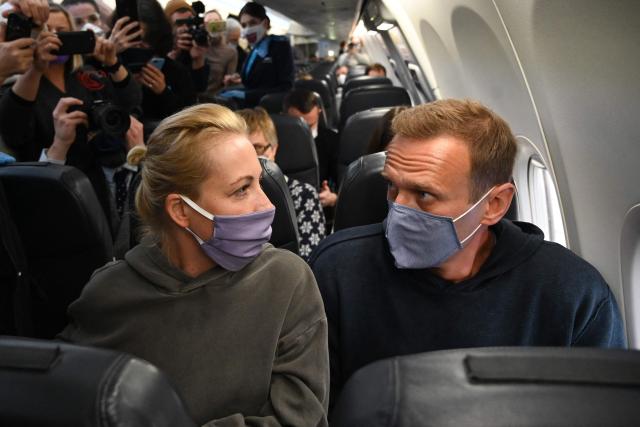 (FILES) Then Russian opposition leader Alexei Navalny and his wife Yulia sit in a Pobeda airlines plane heading to Moscow before take-off from Berlin Brandenburg Airport (BER) in Schoenefeld, southeast of Berlin, on January 17, 2021. The "murder" of late Russian opposition politician Alexei Navalny in an Arctic prison in 2024 is now a "science-proven fact", his widow Yulia Navalnaya said on February 14, 2026 after five European countries said Moscow used a lethal toxic on the Kremlin opponent. (Photo by Kirill KUDRYAVTSEV / AFP)