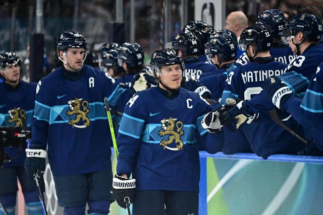 Finland's players celebrate their team's first goal during the men's preliminary round Group B Ice Hockey match between Finland and Italy at the Milano Santagiulia Ice Hockey Arena during the Milano Cortina 2026 Winter Olympic Games in Milan, on February 14, 2026. (Photo by JULIEN DE ROSA / AFP)