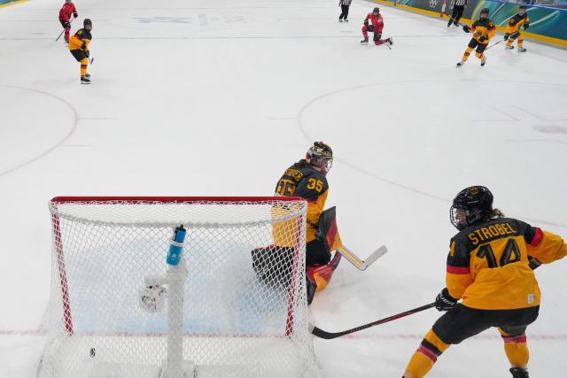 Canada's defender #42 Claire Thompson scores her team's second goal during the women's quarter final ice hockey match between Canada and Germany at the Milano Rho Ice Hockey Arena at the Milano Cortina 2026 Winter Olympic Games in Milan, on February 14, 2026. (Photo by Darko Bandic / POOL / AFP)