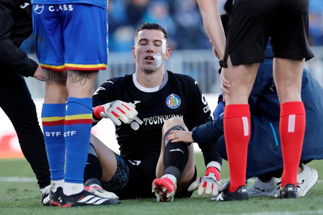 Getafe's Spanish goalkeeper #13 David Soria receives medical attention after resulting injured during the Spanish league football match between Getafe CF and Villarreal CF at Coliseum Alfonso Perez Stadium in Getafe on February 14, 2026. (Photo by Oscar DEL POZO / AFP)
