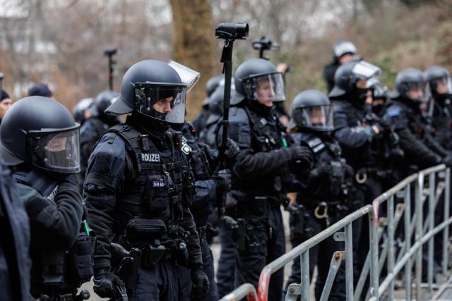 Police is seen during a left-wing demonstration against a march of right-wing extremists in Dresden, eastern Germany, on 14 February, 2026. Right-wing extremists have organised a demonstration on the occasion of the 81st anniversary of the bombing of Dresden during WWII, as the a action alliance "Dresden Wi(e)dersetzen" was calling for a countermarch. (Photo by JENS SCHLUETER / AFP)