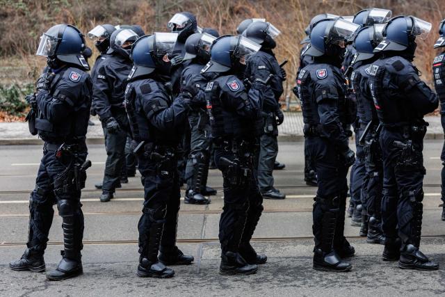 Police is seen during a left-wing demonstration against a march of right-wing extremists in Dresden, eastern Germany, on 14 February, 2026. Right-wing extremists have organised a demonstration on the occasion of the 81st anniversary of the bombing of Dresden during WWII, as the a action alliance "Dresden Wi(e)dersetzen" was calling for a countermarch. (Photo by JENS SCHLUETER / AFP)