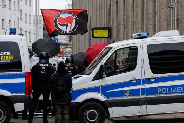 Police is seen during a left-wing demonstration against a march of right-wing extremists in Dresden, eastern Germany, on 14 February, 2026. Right-wing extremists have organised a demonstration on the occasion of the 81st anniversary of the bombing of Dresden during WWII, as the a action alliance "Dresden Wi(e)dersetzen" was calling for a countermarch. (Photo by JENS SCHLUETER / AFP)