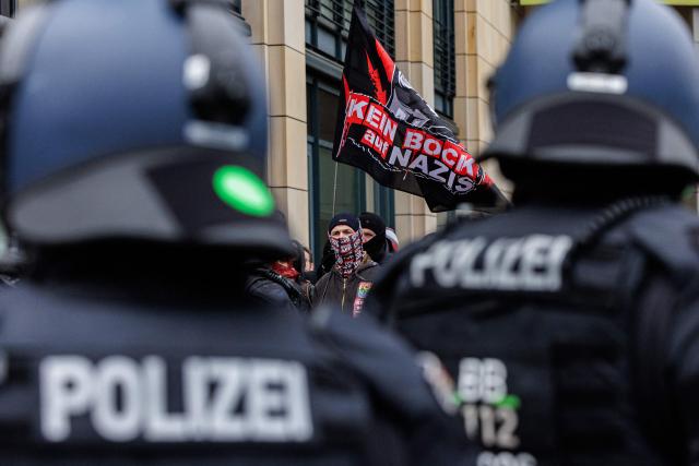 Left-wing demonstrators protest against a march of right-wing extremists in Dresden, eastern Germany, on February 14, 2026. Right-wing extremists have organised a demonstration on the occasion of the 81st anniversary of the bombing of Dresden during WWII, as the a action alliance "Dresden Wi(e)dersetzen" was calling for a countermarch. (Photo by JENS SCHLUETER / AFP)