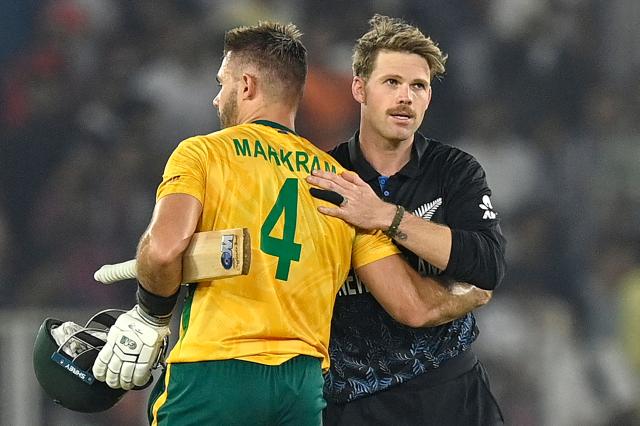 South Africa's captain Aiden Markram (L) is congratulated by New Zealand's Lockie Ferguson for his team's win at the end of the 2026 ICC Men's T20 Cricket World Cup group stage match between New Zealand and South Africa in the Narendra Modi Stadium, Ahmedabad on February 14, 2026. (Photo by Shammi MEHRA / AFP)
