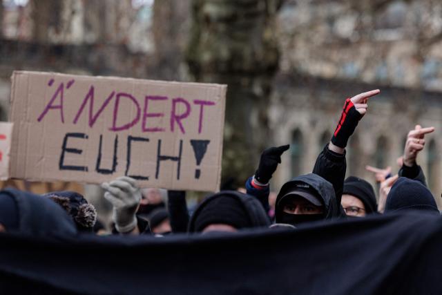 Left-wing demonstrators protest against a march of right-wing extremists in Dresden, eastern Germany, on February 14, 2026. Right-wing extremists have organised a demonstration on the occasion of the 81st anniversary of the bombing of Dresden during WWII, as the action alliance "Dresden Wi(e)dersetzen" was calling for a countermarch. (Photo by JENS SCHLUETER / AFP)