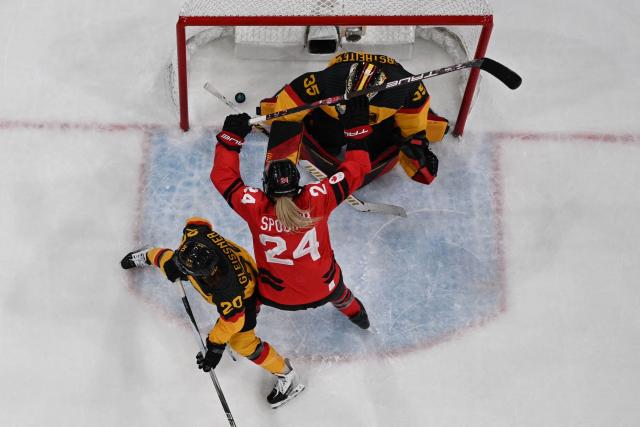 Canada's forward #24 Natalie Spooner celebrates after Canada's forward #10 Sarah Fillier (out of frame) scored their team's third goal during the women's quarter final ice hockey match between Canada and Germany at the Milano Rho Ice Hockey Arena at the Milano Cortina 2026 Winter Olympic Games in Milan, on February 14, 2026. (Photo by Alexander NEMENOV / AFP)