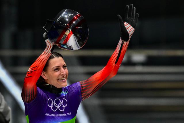 Austria's Janine Flock reacts in the finish area after competing in the skeleton women's heat 3 at Cortina Sliding Centre during the Milano Cortina 2026 Winter Olympic Games in Cortina d'Ampezzo on February 14, 2026. (Photo by Stefano RELLANDINI / AFP)