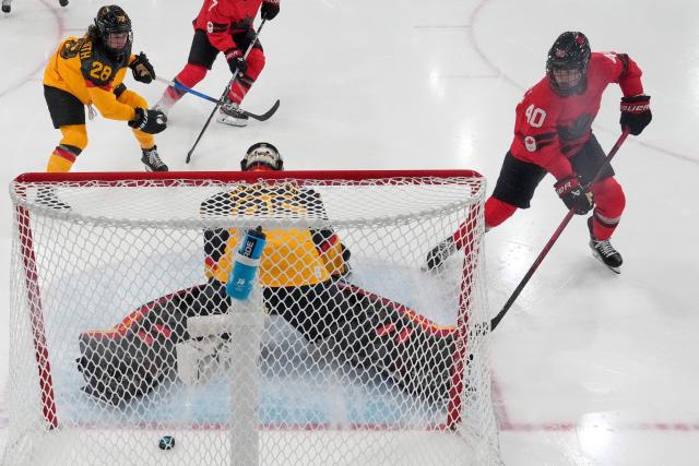 Canada's forward #40 Blayre Turnbull scores her team's fourth goal past Germany's #35 Sandra Abstreiter during the women's quarter final ice hockey match between Canada and Germany at the Milano Rho Ice Hockey Arena at the Milano Cortina 2026 Winter Olympic Games in Milan, on February 14, 2026. (Photo by Darko Bandic / POOL / AFP)