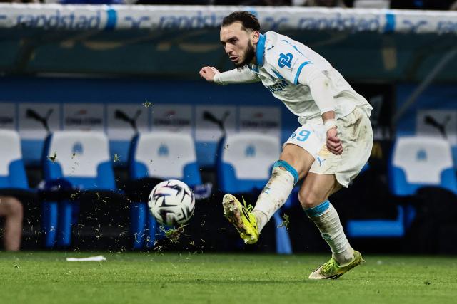 Marseille's Algerian forward #09 Amine Gouiri passes the ball  during the French L1 football match between Olympique de Marseille (OM) and RC Strasbourg at the Stade Velodrome in Marseille, southern France, on February 14, 2026. (Photo by Thibaud MORITZ / AFP)